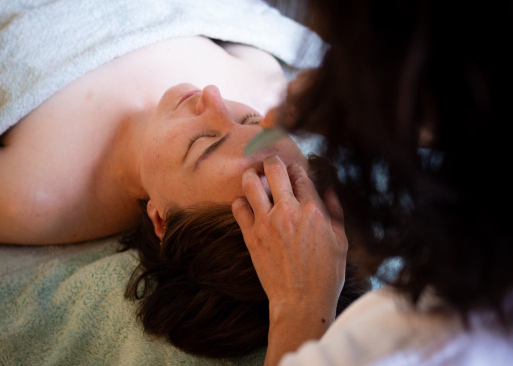 Woman receiving face massage