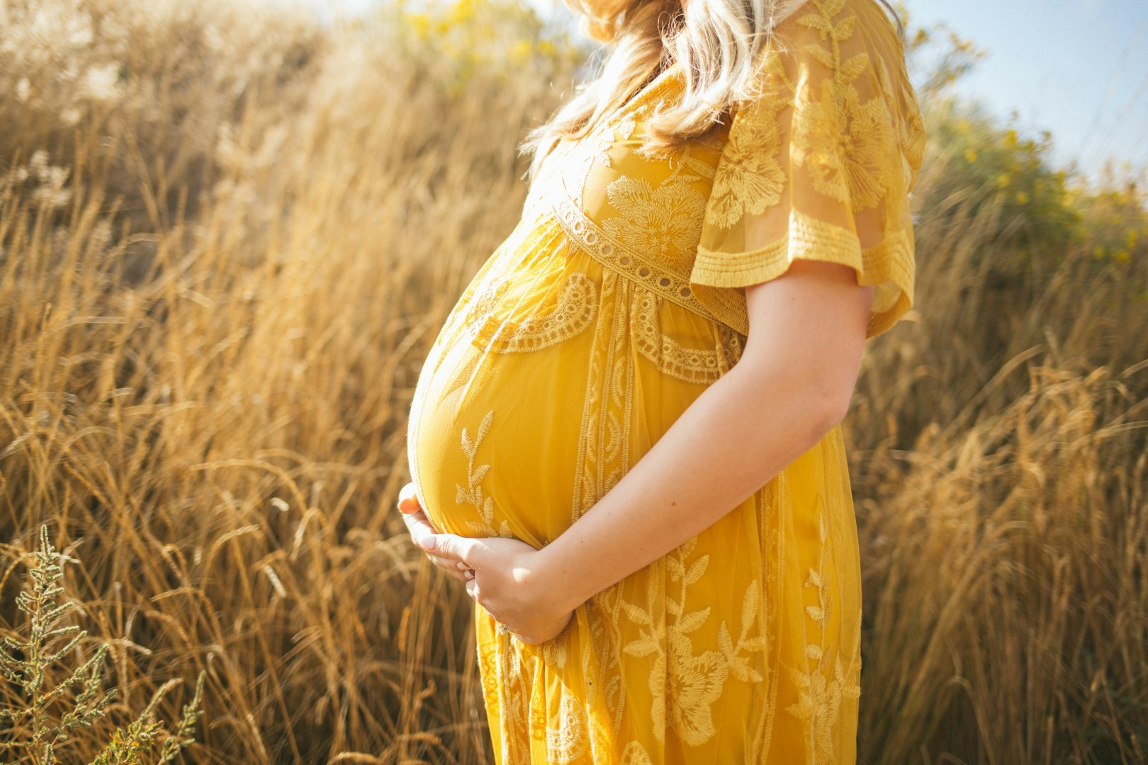 Woman in pregnancy holding her belly