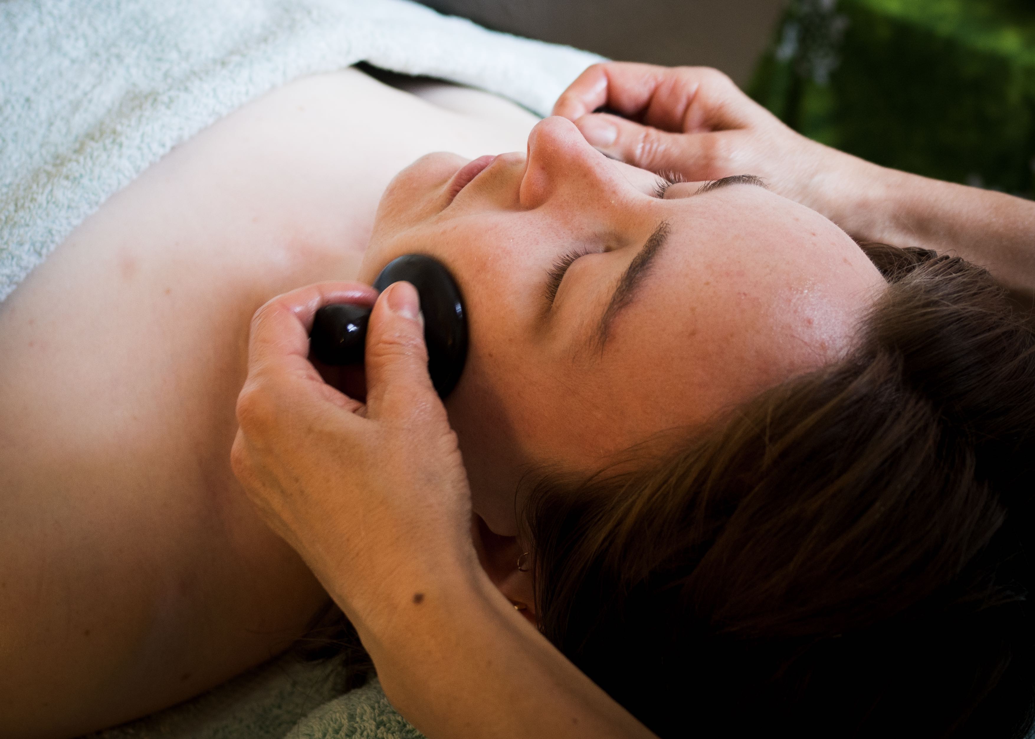 Woman receiving face massage